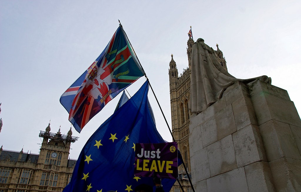 Ashamed to be British. Flags near the Houses of Parliament, Westminster, London. Photo: ChiralJon (CC BY 2.0).