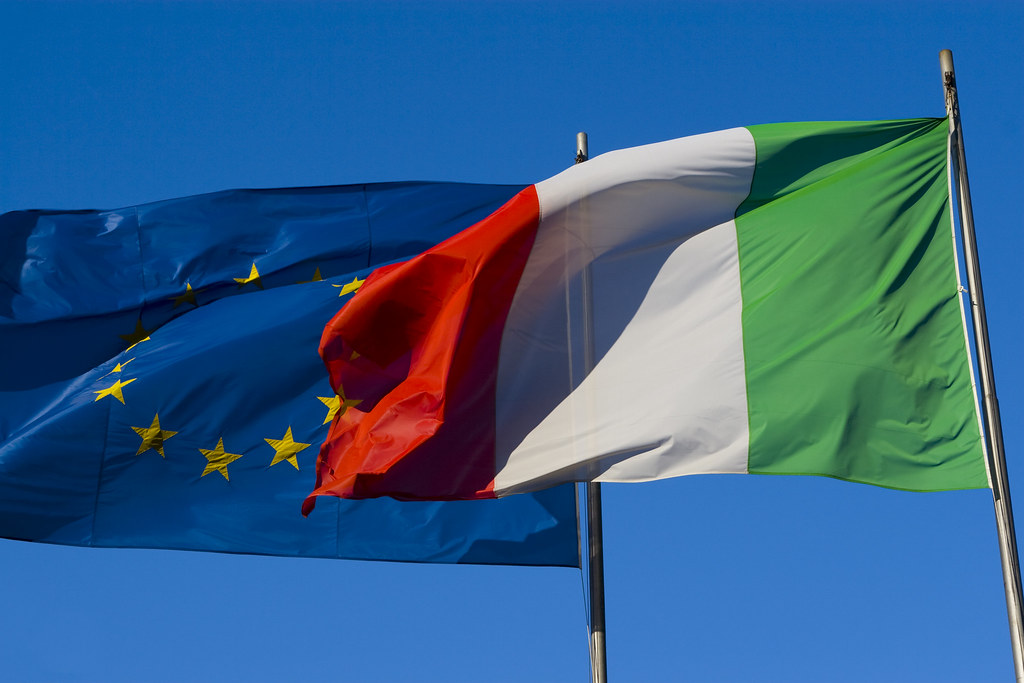 Italy’s budget battle with the European Commission.Flags of Italy and the European Union