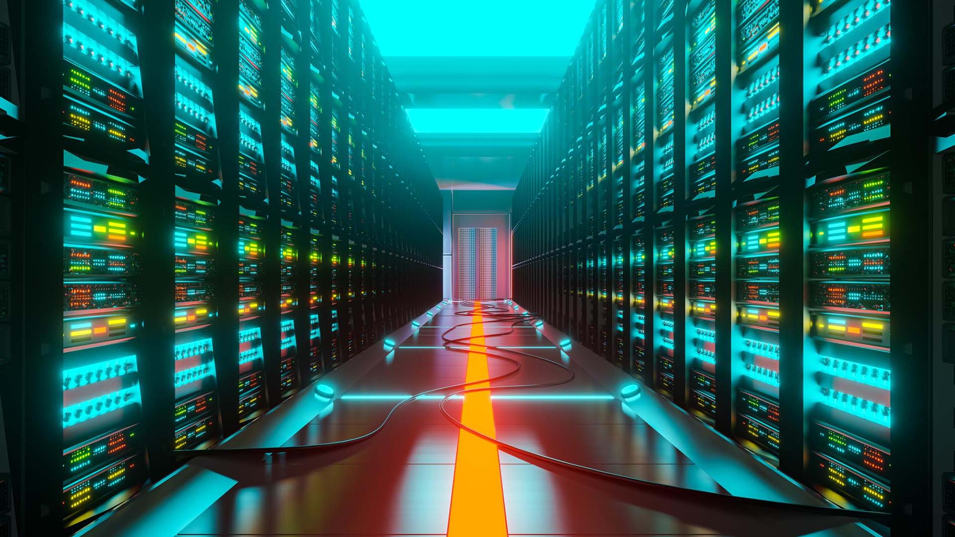 Centro de datos con largos pasillos de racks de servidores iluminados en tonos azul y verde, con cables visibles en el suelo que recorren la sala.