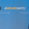 Flags of Spain and NATO with the hashtag #WeAreNATO (cropped image)