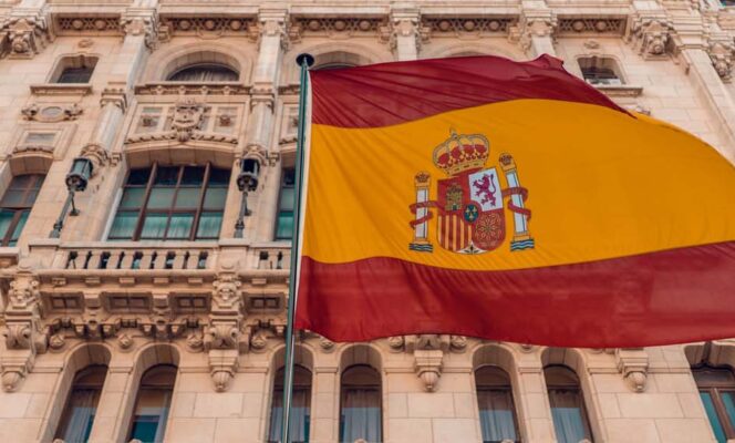 Spanish flag on pole beside building in Madrid