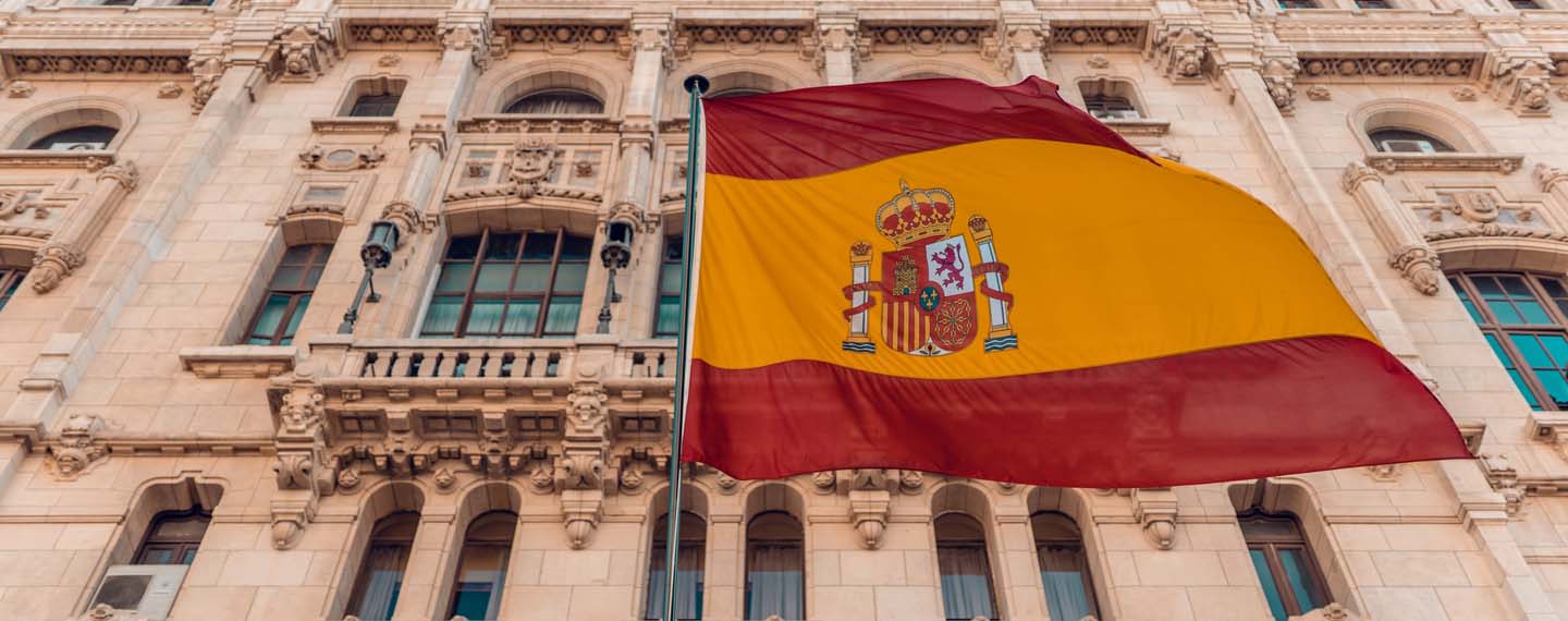 Spanish flag on pole beside building in Madrid