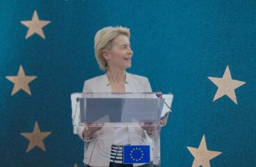 Political cycle. Ursula Von der Leyen, President of the European Commission, and the European Union flag.