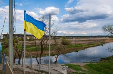 Una bandera de Ucrania ondea junto a un puente sobre el río Irpin, al lado de Hostomel, en las afueras de la ciudad de Kyiv