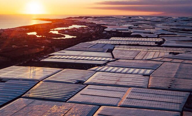 Spain prays for rain on the plain. Aerial panoramic of greenhouses in Almerimar (Spain) at the sunset