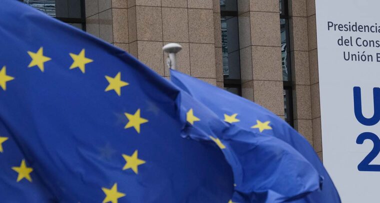 Banderas de la UE y banner con el logo de la Presidencia Española del Consejo de la UE como decoración en el edificio Europa en Bruselas, Bélgica