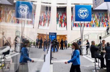 A woman walks past the IMF Today Production box during the 2022 Annual Meetings at the International Monetary Fund (IMF)