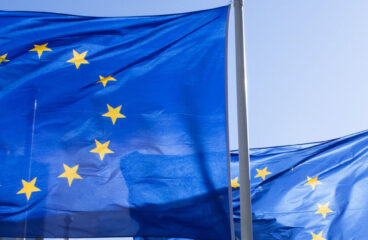 Three European Union flags fly in the financial district of La Défense in Paris, France. Team Europe
