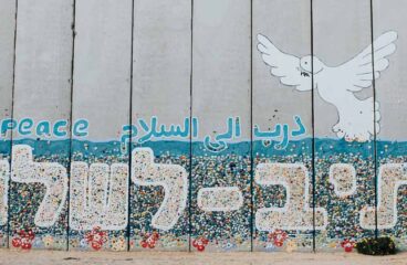 A wall at Netiv HaAsara facing the Gaza border reads the words “Path to Peace” in Hebrew, Arabic, and English. Netiv HaAsara is a moshav in southern Israel. Located in the north-west Negev, it nearly borders the Gaza Strip