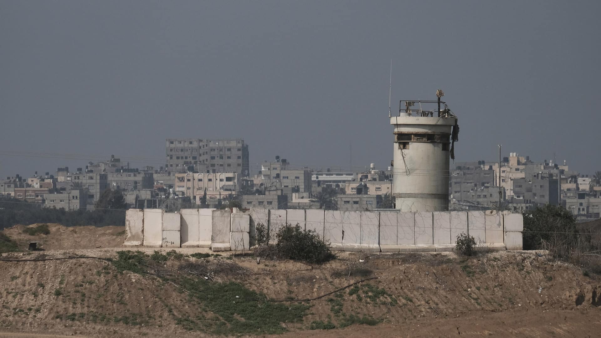 Gaza border with Israel. Distant view of residential houses and buildings in the northern part of the Gaza strip across an Israeli army post