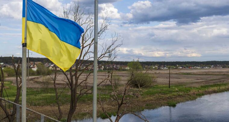 Flag of Ukraine waving on a bridge over the Irpin river, next to Hostomel, on the outskirts of Kyiv