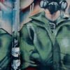 Graffiti detrás de Bloor West, cerca de la estación de metro Dundas West en Toronto (Canadá). El graffiti muestra en primer plan unas manos levantadas haciendo el símbolo de paz contra el fondo donde hay tres figuras enmascaradas que representan fuerzas militares y policiales y a la izquierda un rostro difuminado expresando un grito de ira