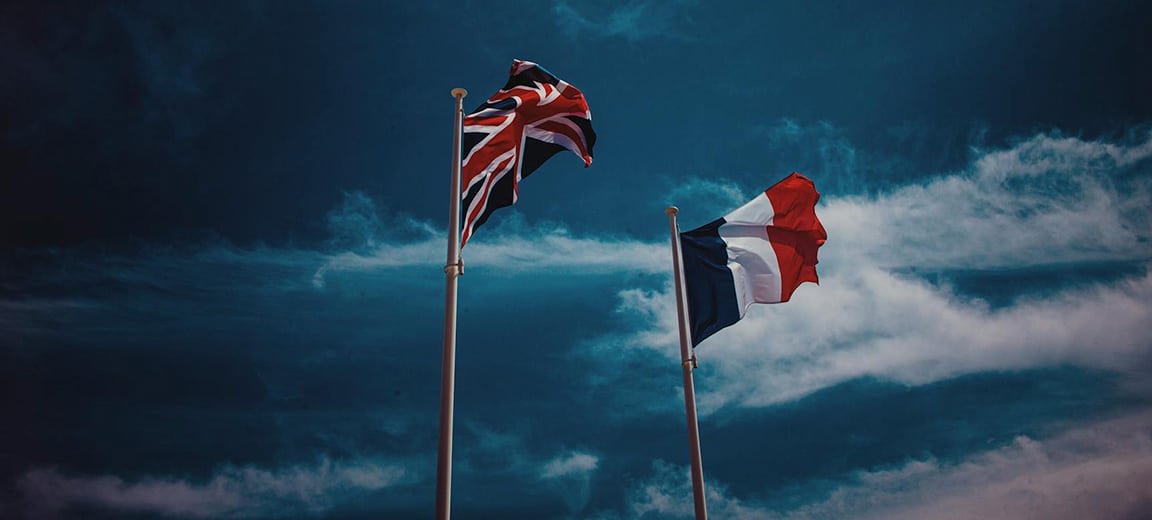 UK and French flags waving.