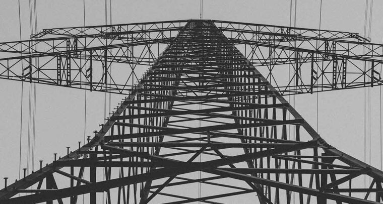 Electrical transmission tower from low angle. Geopolitics of the global energy