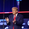 Former US President Donald Trump applauds as he stands during his meeting with attendees at the People's Convention at Huntington Place in Detroit, Michigan, in June 2024