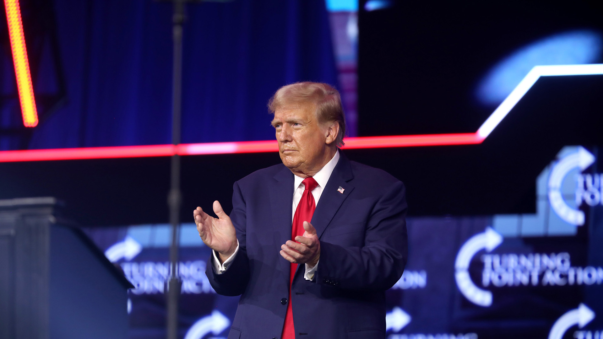 Former US President Donald Trump applauds as he stands during his meeting with attendees at the People's Convention at Huntington Place in Detroit, Michigan, in June 2024