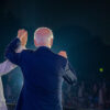 US President Joe Biden, in a navy blue suit, and Vice President Kamala Harris, in a beige suit, in front of a crowd of people during the 4th of July celebration at the White House