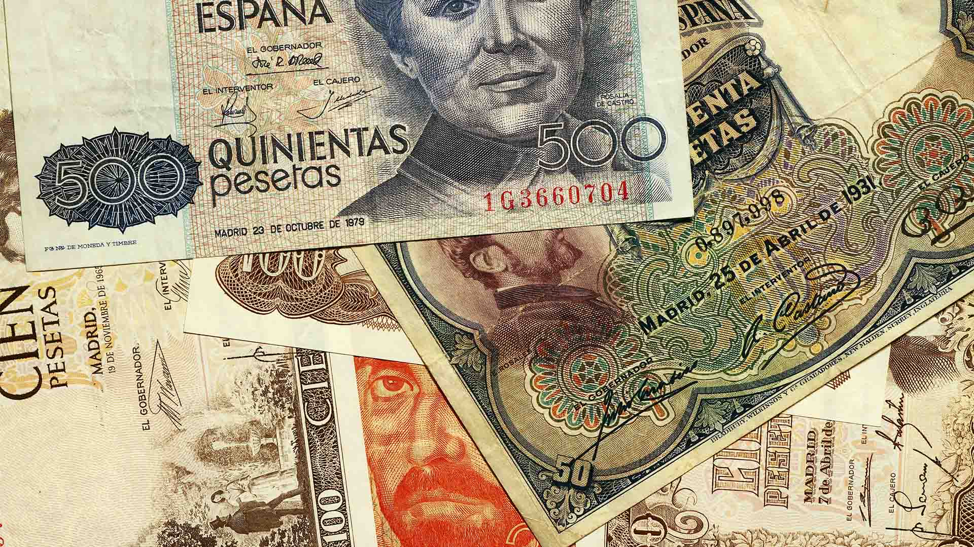 Various old Spanish peseta banknotes of different denominations, including 500, 100 and 50 pesetas, with historical details and faces of important figures in Spanish history. Spain