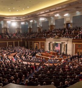 View of the floor of the US Congress during the 2018 State of the Union address, with the president at the podium facing lawmakers. Donald Trump