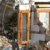 Partially collapsed building in Letur (Albacete) with shattered walls, exposed bricks, broken windows, and debris scattered around, showing damage caused by the ‘DANA’ storm. water