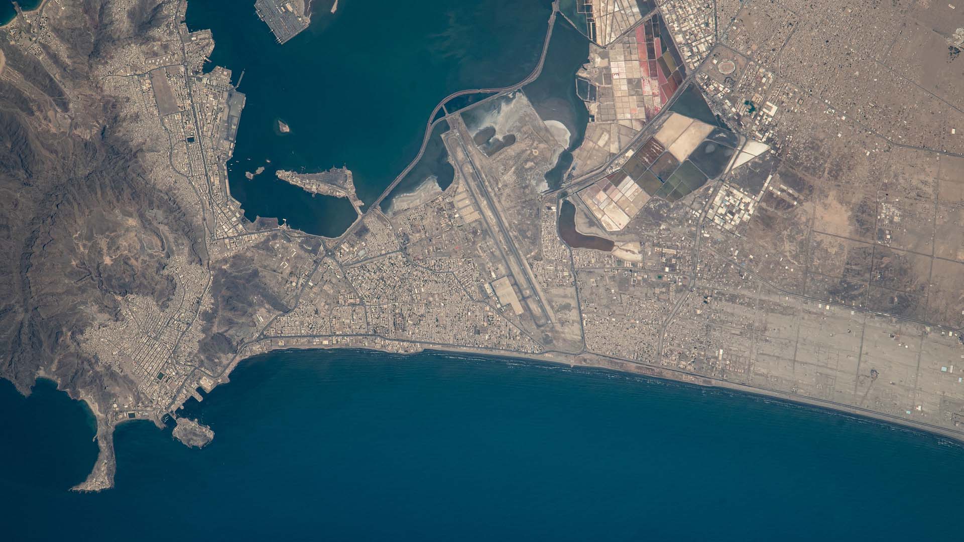 Overhead satellite view of Aden (Yemen), showing a top-down perspective of the city’s natural harbour. Houthi