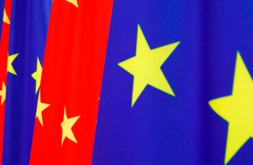 A row of European Union flags (blue with yellow stars) and Chinese flags (red with yellow stars) waving side by side during the 2020 EU–China summit. China