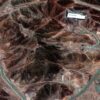 Vista satelital de la instalación de enriquecimiento de Fordo, tomada el 14 de junio de 2025. El complejo, ubicado en una zona montañosa, está rodeado por una carretera perimetral. En la parte superior de la imagen se distingue el techo blanco de un edificio. Irán