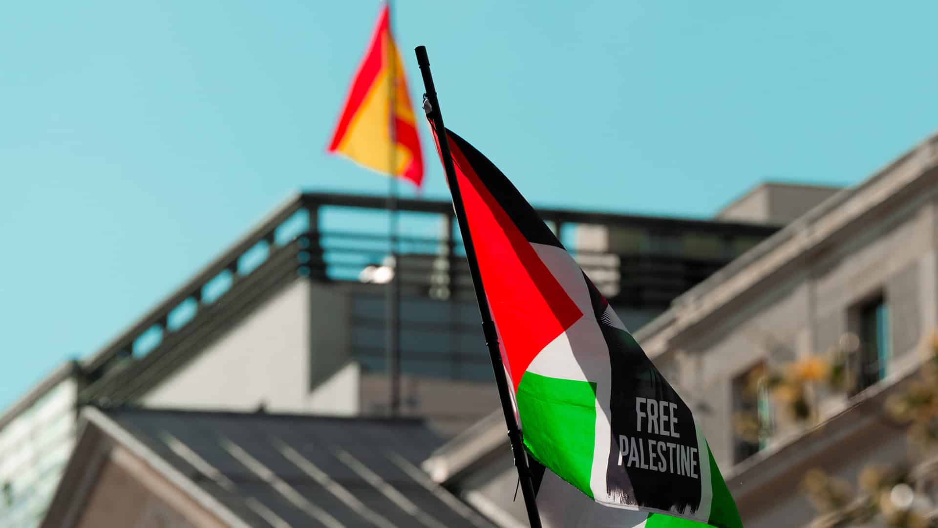 Una bandera con el lema “Free Palestine” ondea durante una manifestación a favor de Palestina frente al edificio del Congreso de los Diputados en Madrid, en cuyo alto, al fondo la imagen, ondea una bandera española (20/05/2025).