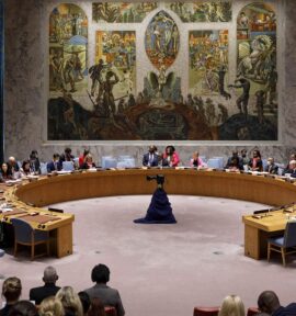 Members of the UN Security Council gathered around a circular table in the conference room with a mural in the background, to discuss the Women, Peace and Security Agenda (New York, 2022).