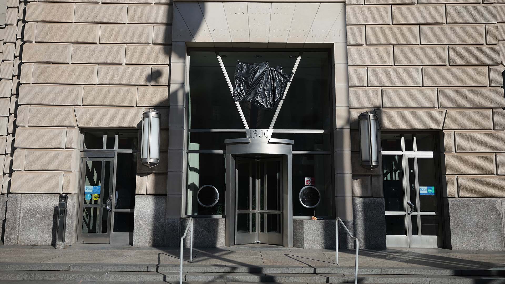 Main entrance to the United States Agency for International Development (USAID) building in Washington, D.C., with the sign covered by a black tarpaulin following its closure.