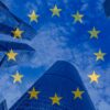 Composition of a skyscrapers photo on the background of the European Union flag.