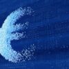 A euro symbol made up of small blue pixels scattered across a digital background, representing financial transformation and the digital economy.