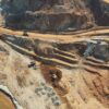 Aerial view of a nickel mine on the island of Sulawesi, Indonesia. Haul roads, excavators and lorries transporting ore between the extraction and storage areas can be seen.
