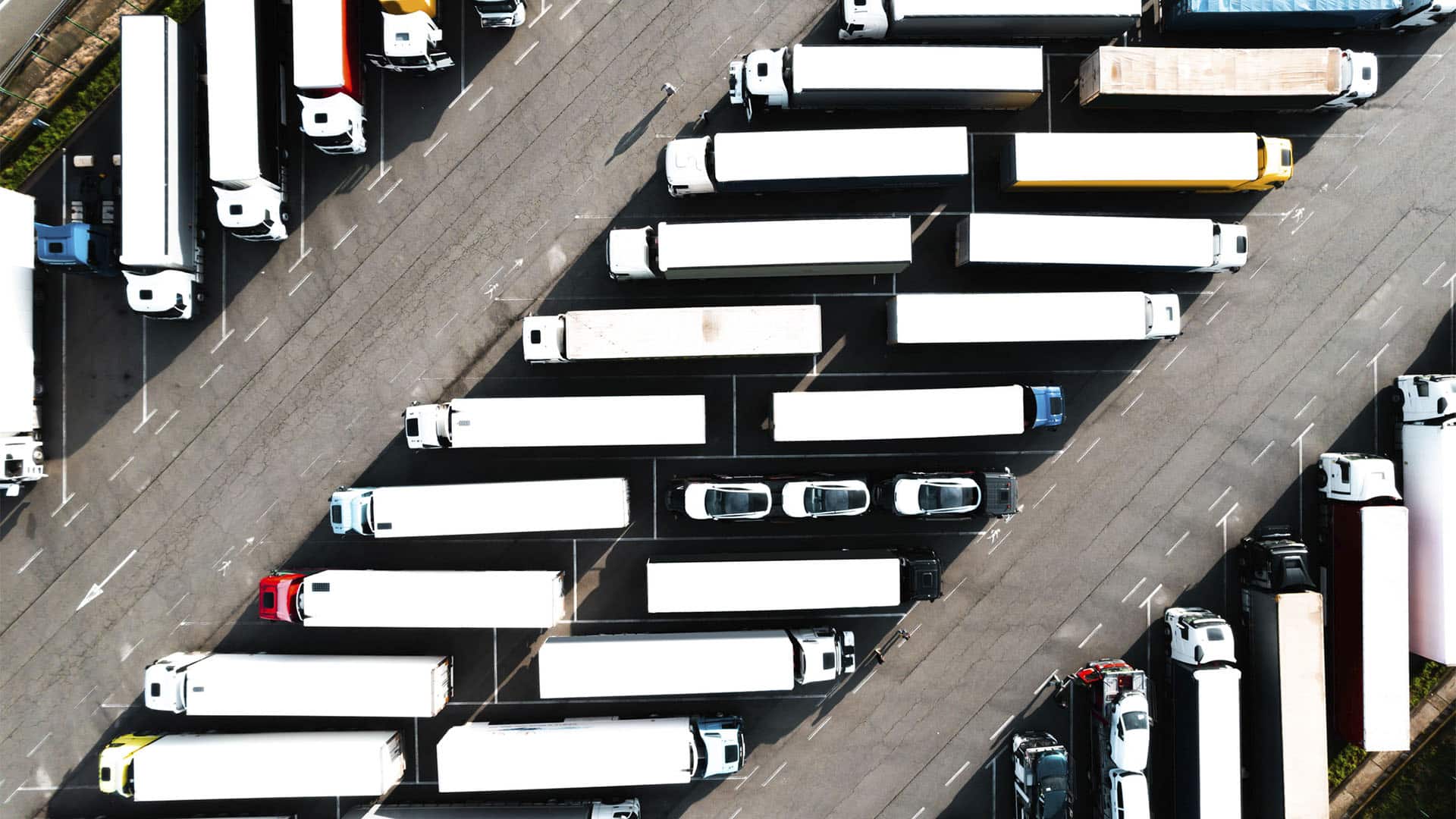 Aerial view of lorries and trailers parked at a logistics hub in Llinars del Vallès, Barcelona, Spain.
